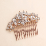 A decorative hair accessory with a floral design and numerous sparkling crystal elements.