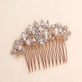 A decorative hair accessory with a floral design and numerous sparkling crystal elements.