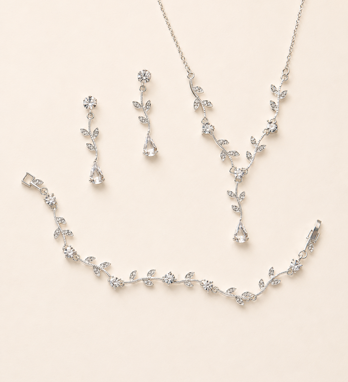 a delicate and elegant jewelry set consisting of a necklace, earrings, and a bracelet, all adorned with small, sparkling crystal elements.