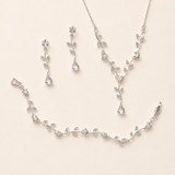 a delicate and elegant jewelry set consisting of a necklace, earrings, and a bracelet, all adorned with small, sparkling crystal elements.