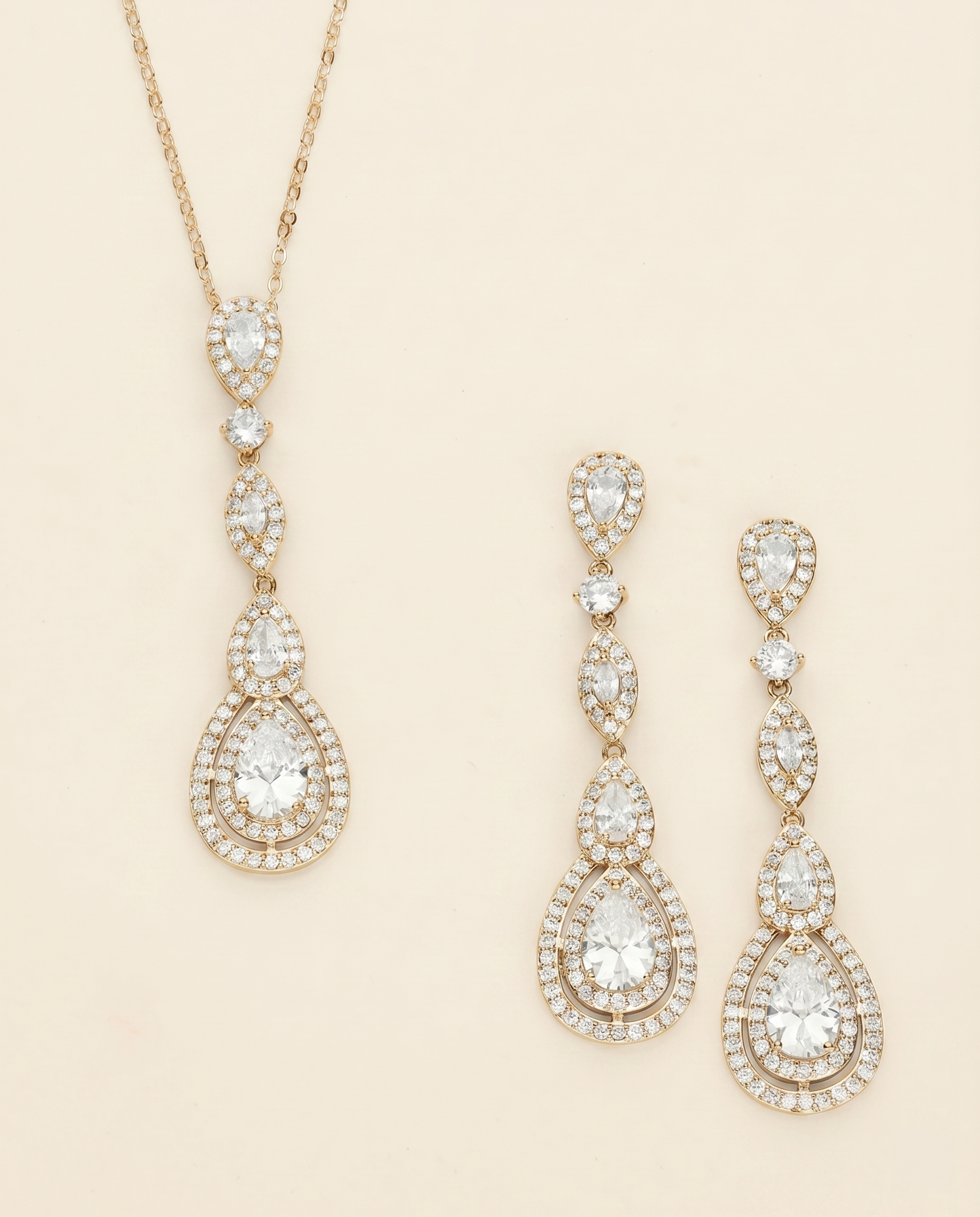 A gold necklace with a pendant and a pair of gold earrings with a pendant are displayed against a light beige background.