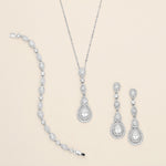 a collection of elegant jewelry pieces, including a necklace, a bracelet, and earrings, all adorned with sparkling diamonds.