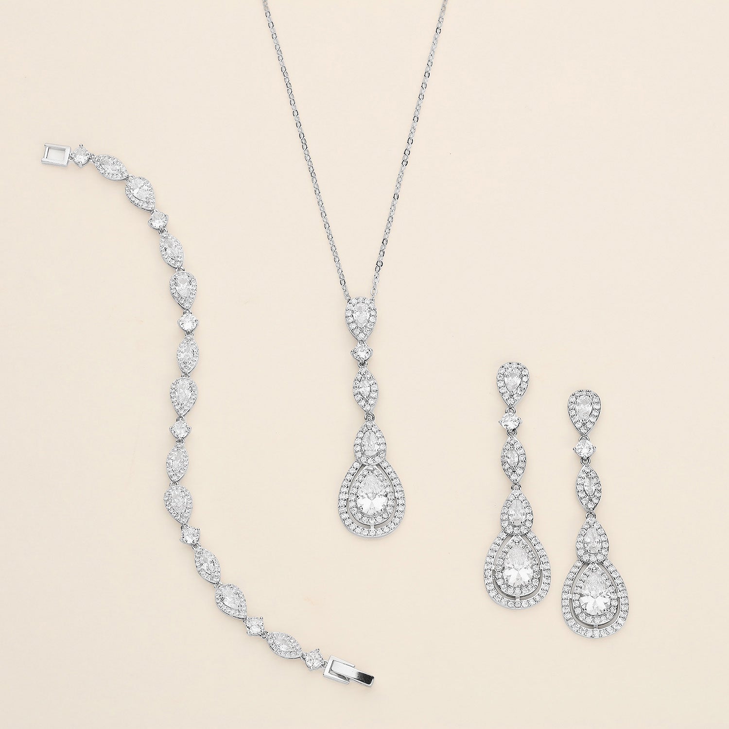a collection of elegant jewelry pieces, including a necklace, a bracelet, and earrings, all adorned with sparkling diamonds.