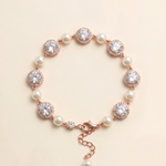 A bracelet with a clasp and a row of pearls and diamonds on a beige background.