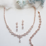 a necklace and earrings on a white surface