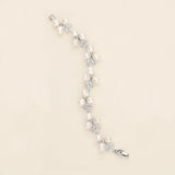 a white pearl and crystal bracelet on a white background