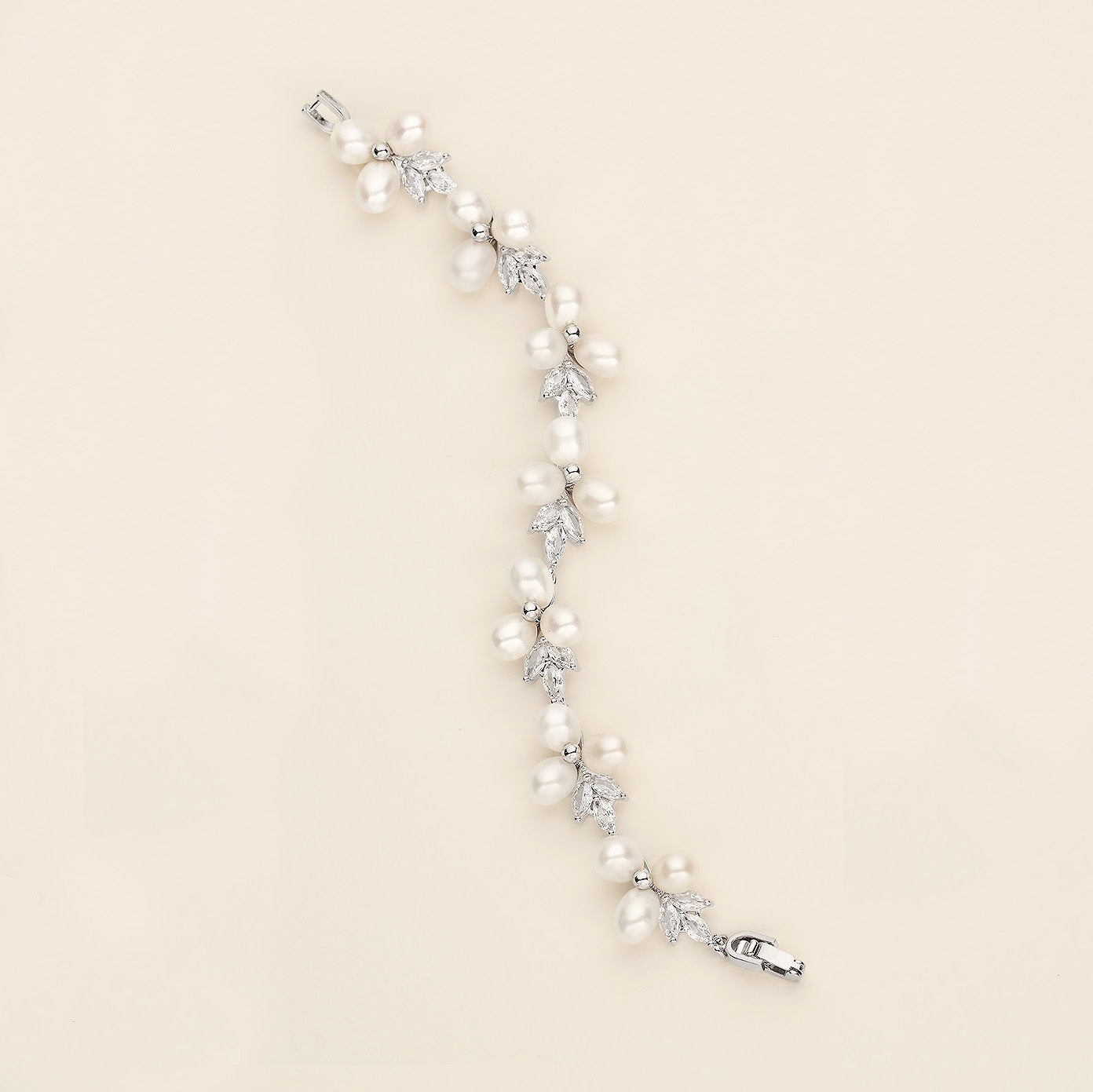 a white pearl and crystal bracelet on a white background