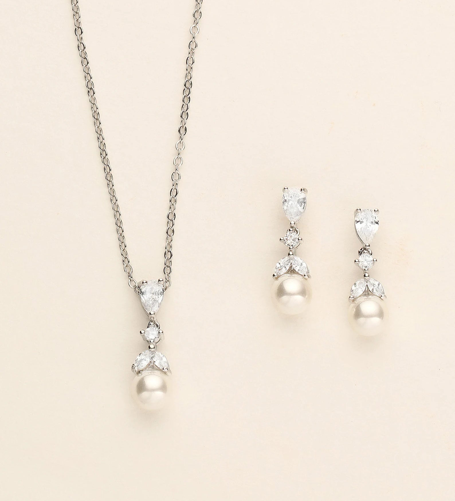 a necklace and earring set with pearls