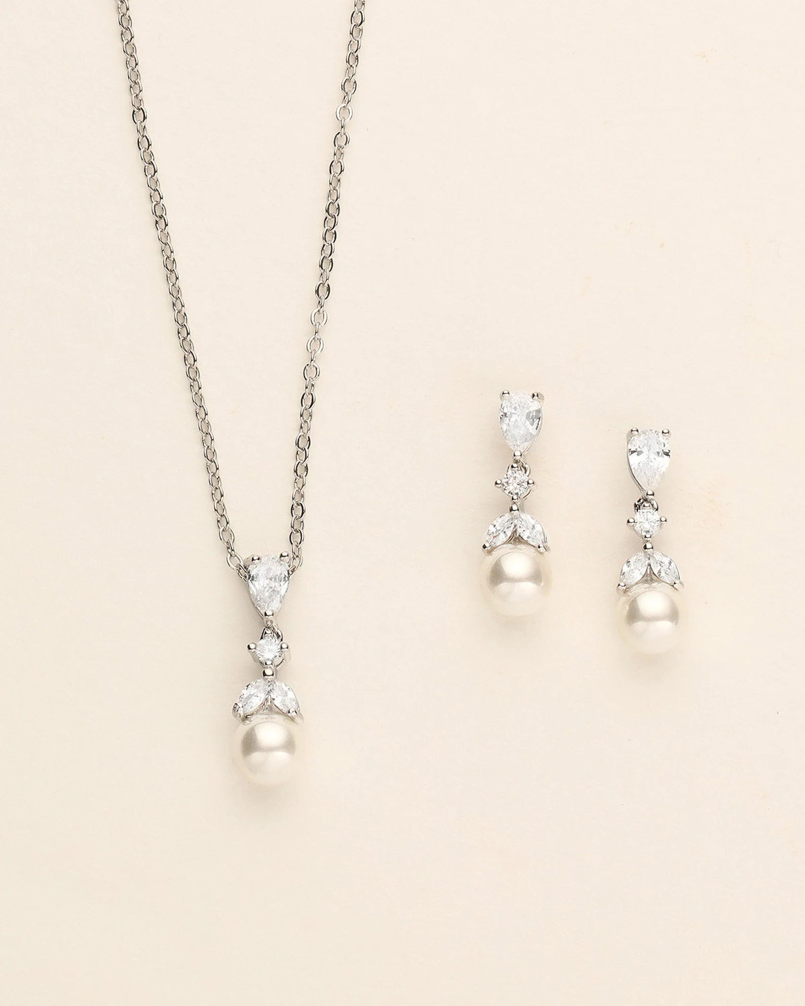 a necklace and earring set with pearls