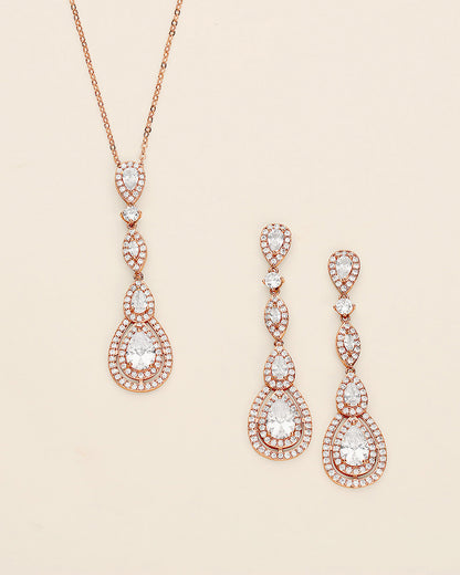 a pair of earrings and a necklace on a white background