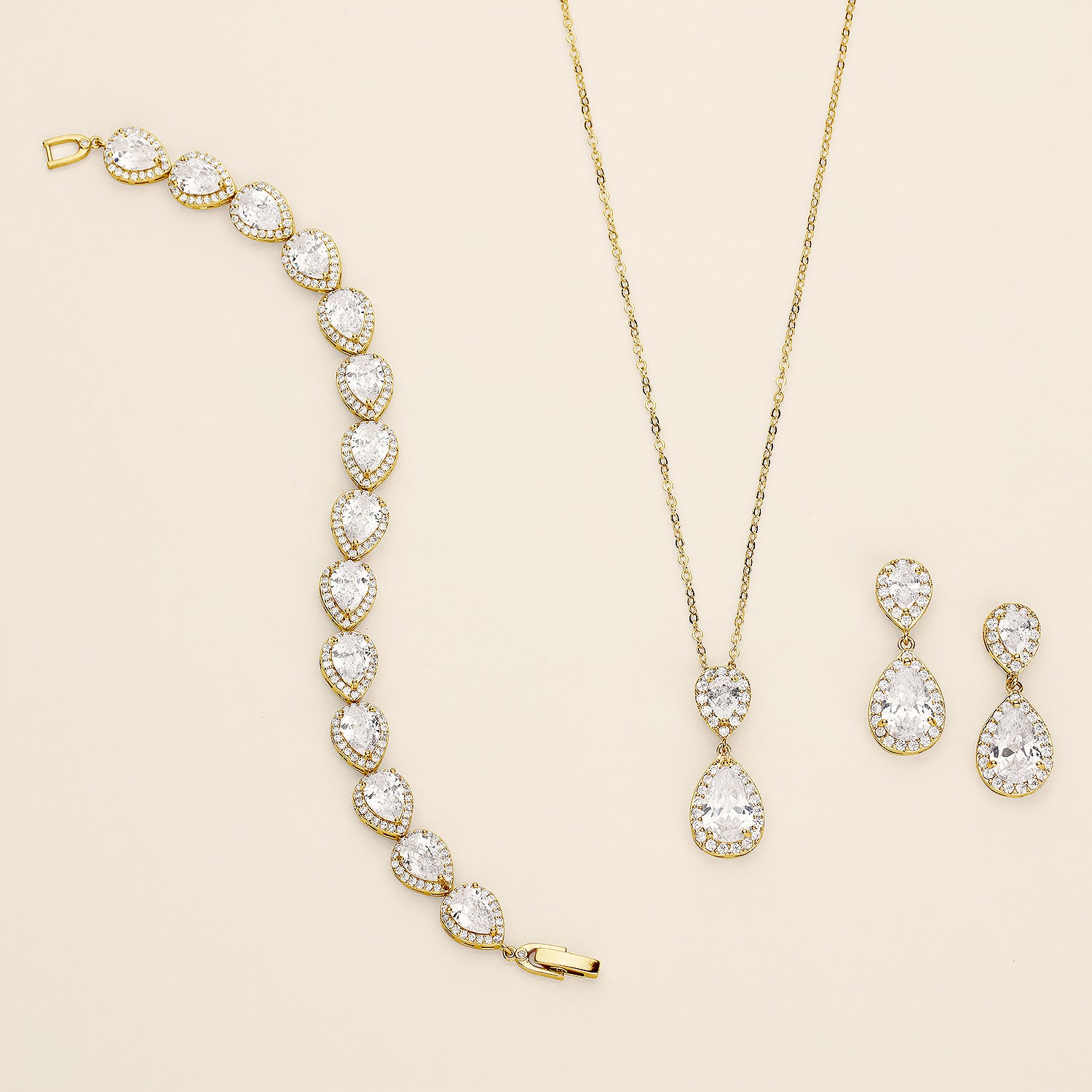 a necklace, bracelet, and earrings on a white surface
