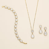 a necklace, bracelet, and earrings on a white surface