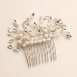A decorative hair accessory with a comb and a floral design made of pearls and crystals.