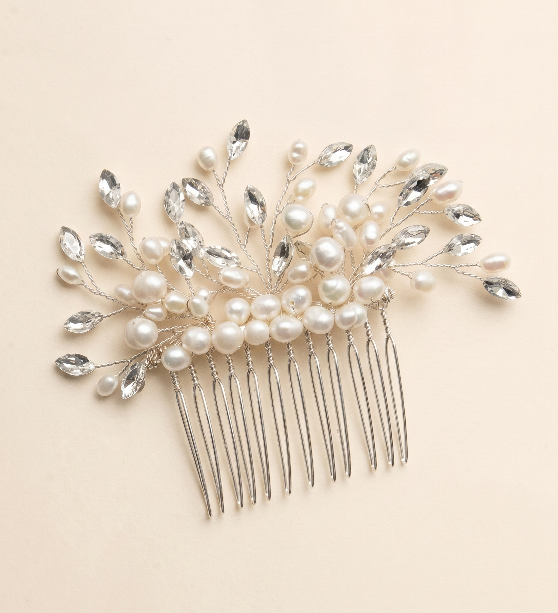 A decorative hair accessory with a comb and a floral design made of pearls and crystals.