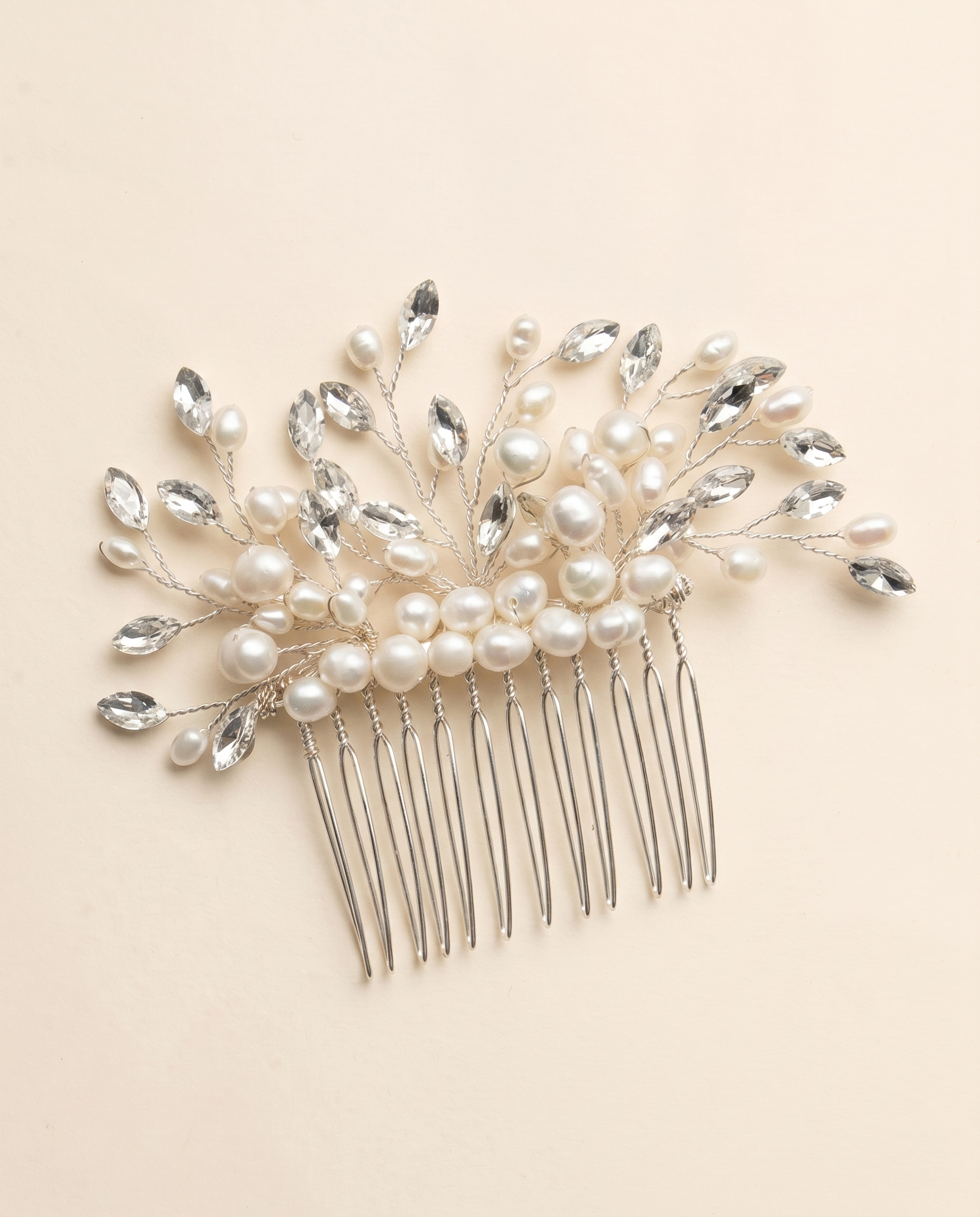 A decorative hair accessory with a comb and a floral design made of pearls and crystals.
