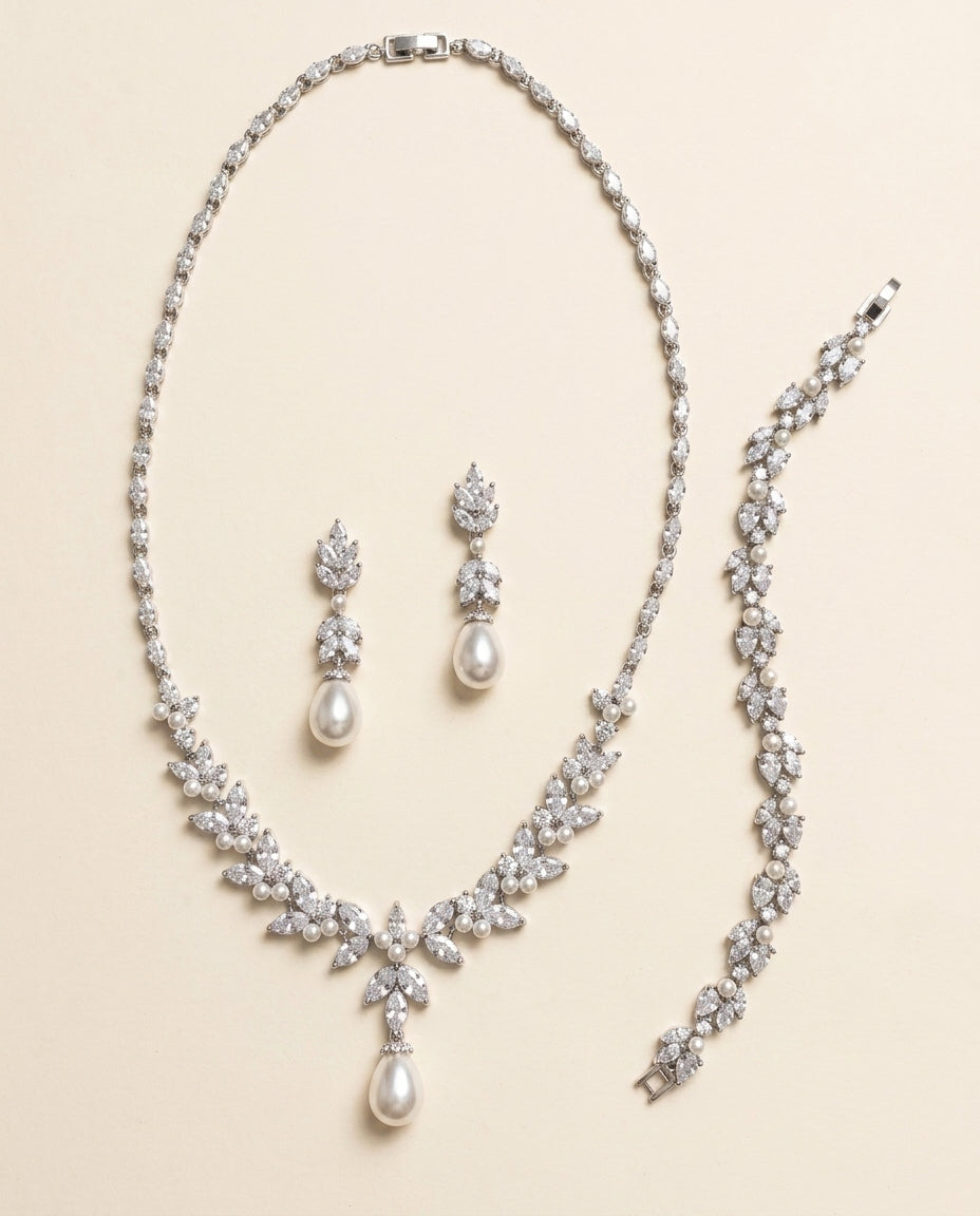 a collection of elegant jewelry pieces, including a necklace, earrings, and a bracelet, all adorned with sparkling diamonds and pearls.