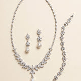a collection of elegant jewelry pieces, including a necklace, earrings, and a bracelet, all adorned with sparkling diamonds and pearls.