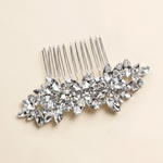 A silver hairbrush adorned with numerous sparkling crystal stones.