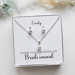 A necklace and earring set presented in a white box, with a personalized message on the box.