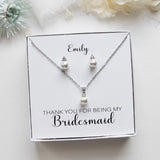 A necklace and earring set presented in a white box, with a personalized message on the box.