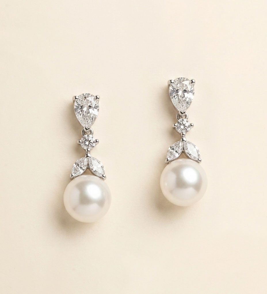 A pair of elegant earrings with pearls and diamonds.