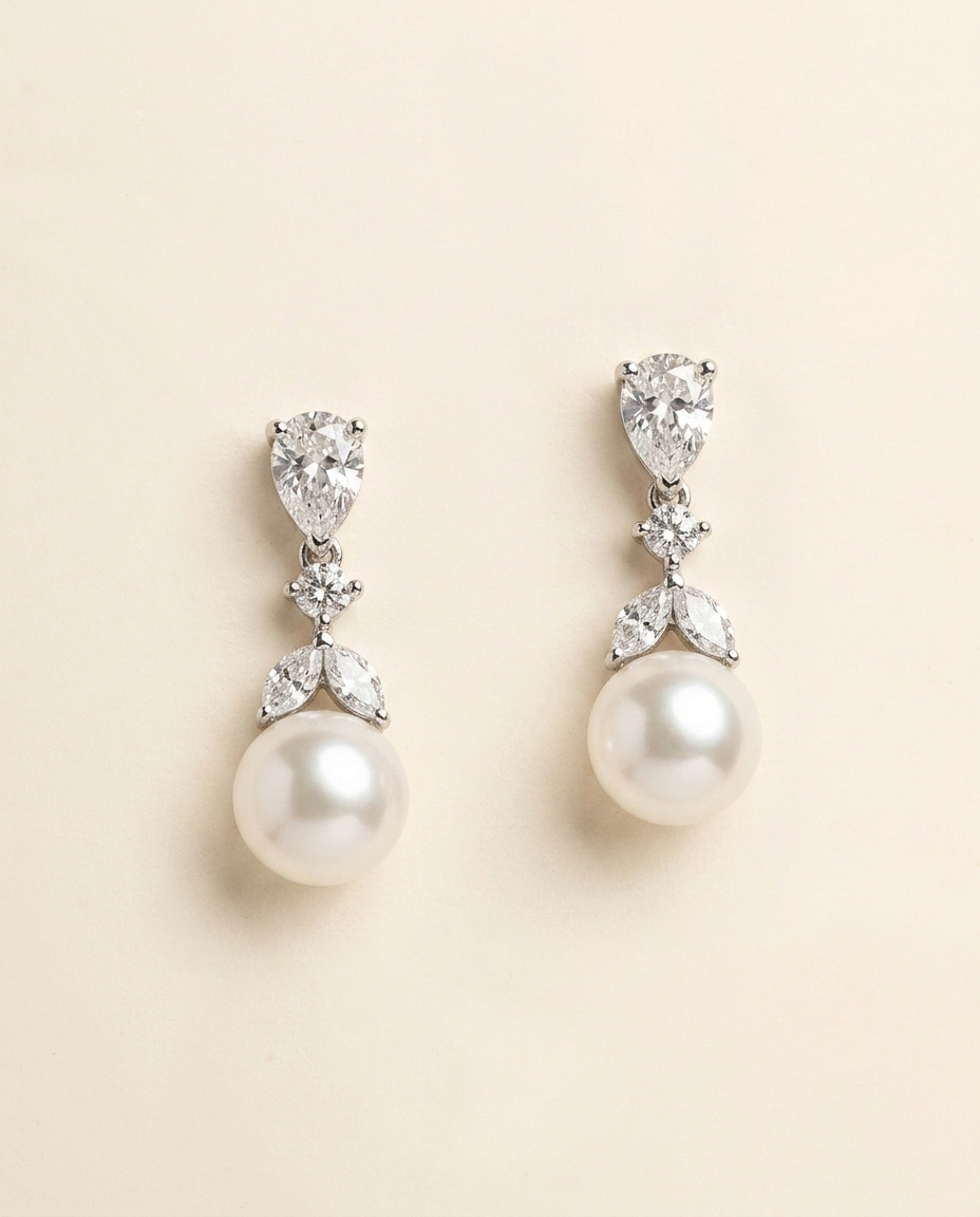 A pair of elegant earrings with pearls and diamonds.