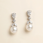 A pair of elegant earrings with pearls and diamonds.