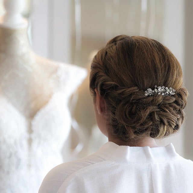 a woman is looking at a dress on a mannequin