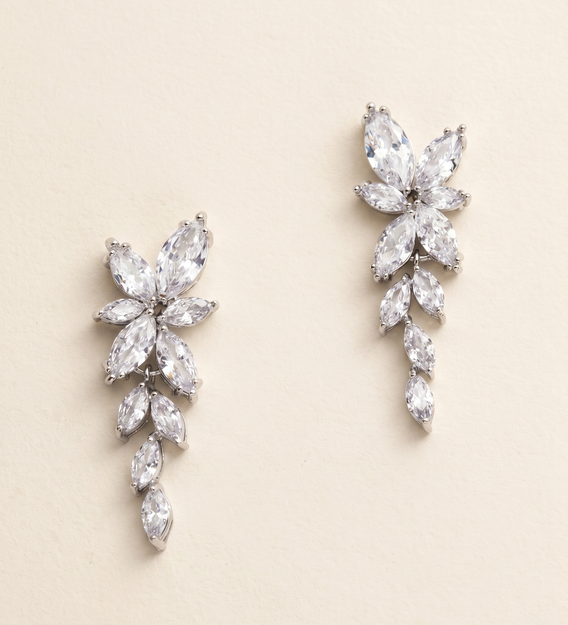 A pair of elegant earrings with large, clear gemstones arranged in a floral design.