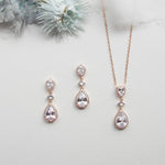 a necklace, earrings, and ring sitting on a table