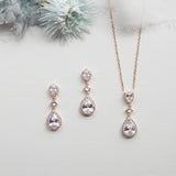 a necklace, earrings, and ring sitting on a table