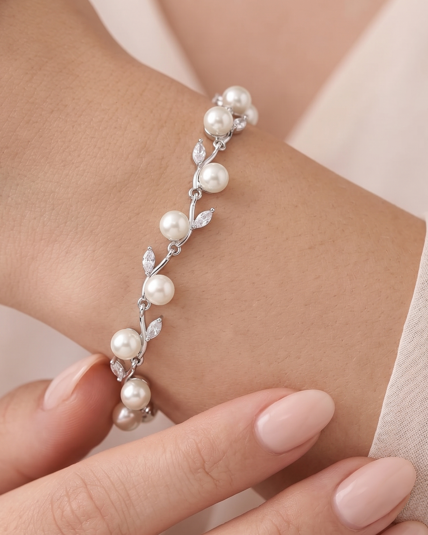 A close-up image of a person's wrist wearing a bracelet with a delicate design of white pearls and small diamonds.