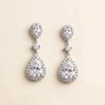 A pair of elegant earrings with large, clear gemstones set in a halo-like design.