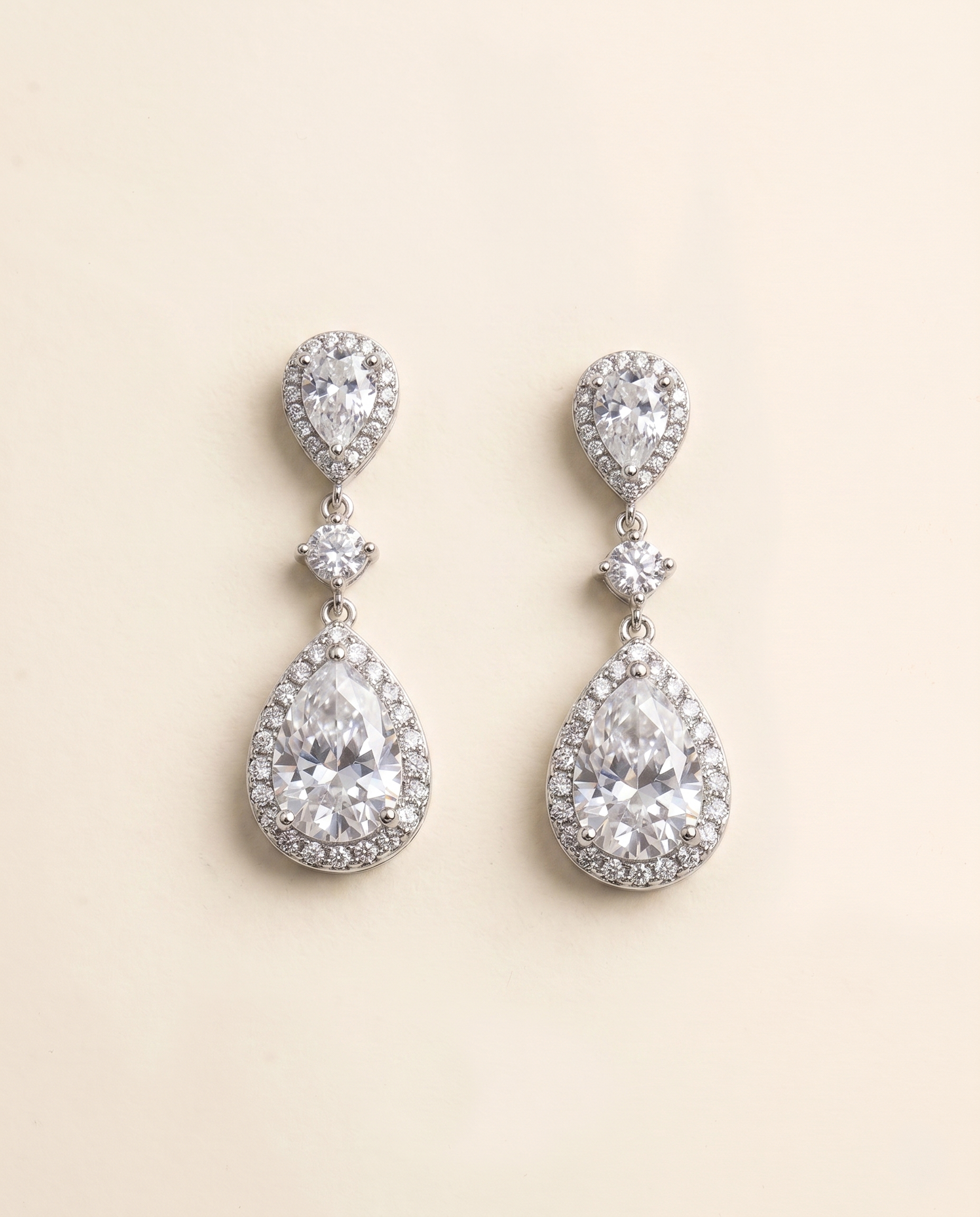 A pair of elegant earrings with large, clear gemstones set in a halo-like design.