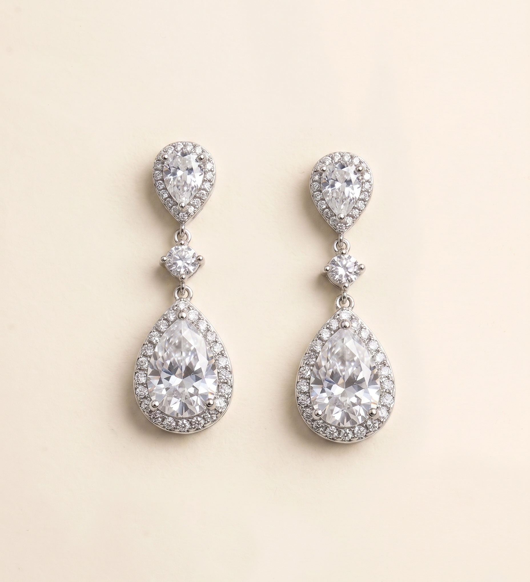 A pair of elegant earrings with large, clear gemstones set in a halo-like design.