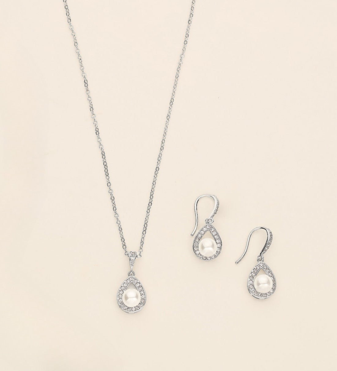 a necklace, bracelet, and earrings are shown on a white surface