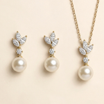 A set of three pearl earrings and a necklace with pearls and diamonds.