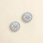A pair of elegant diamond earrings with a large central diamond surrounded by smaller diamonds, set in a halo of smaller diamonds.