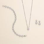 a necklace, earrings, and bracelet on a white surface