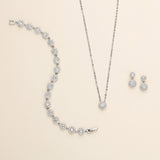 a necklace, earrings, and bracelet on a white surface
