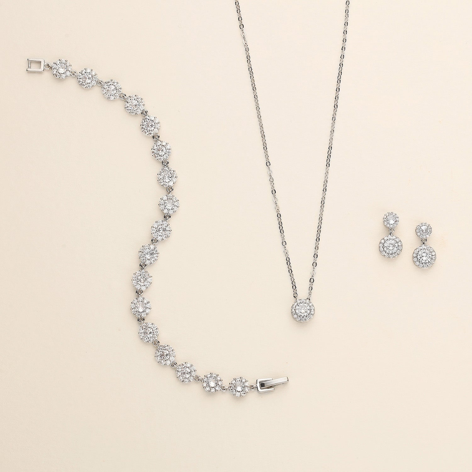 a collection of jewelry, including a necklace, earrings, and a bracelet, all featuring a sparkling diamond design.