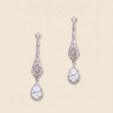 A pair of elegant diamond earrings with intricate designs and dangling crystal stones.