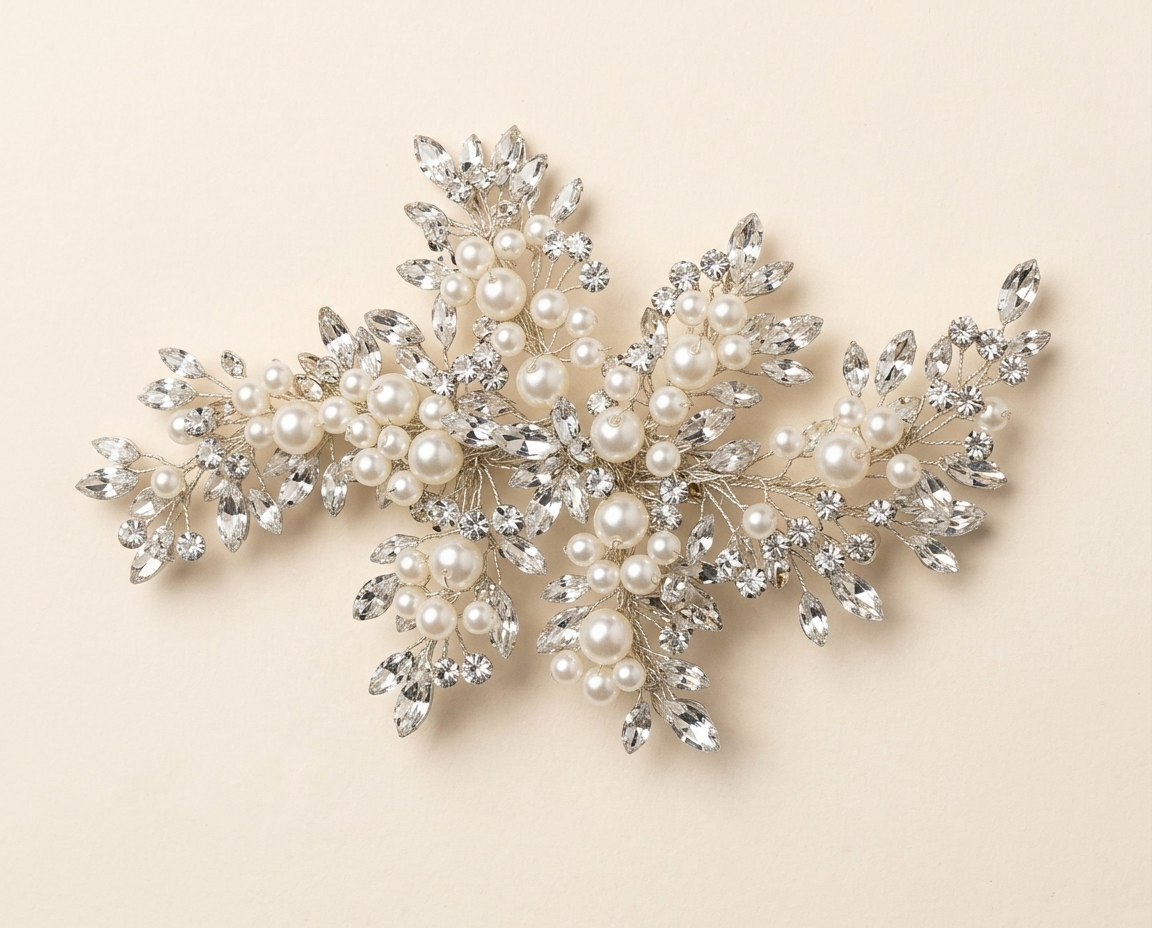 A decorative piece of jewelry with a combination of pearls, crystals, and leaves.