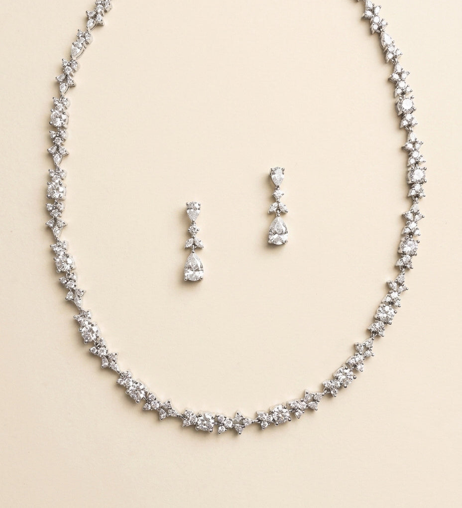 A necklace and earrings set made of sparkling diamonds.