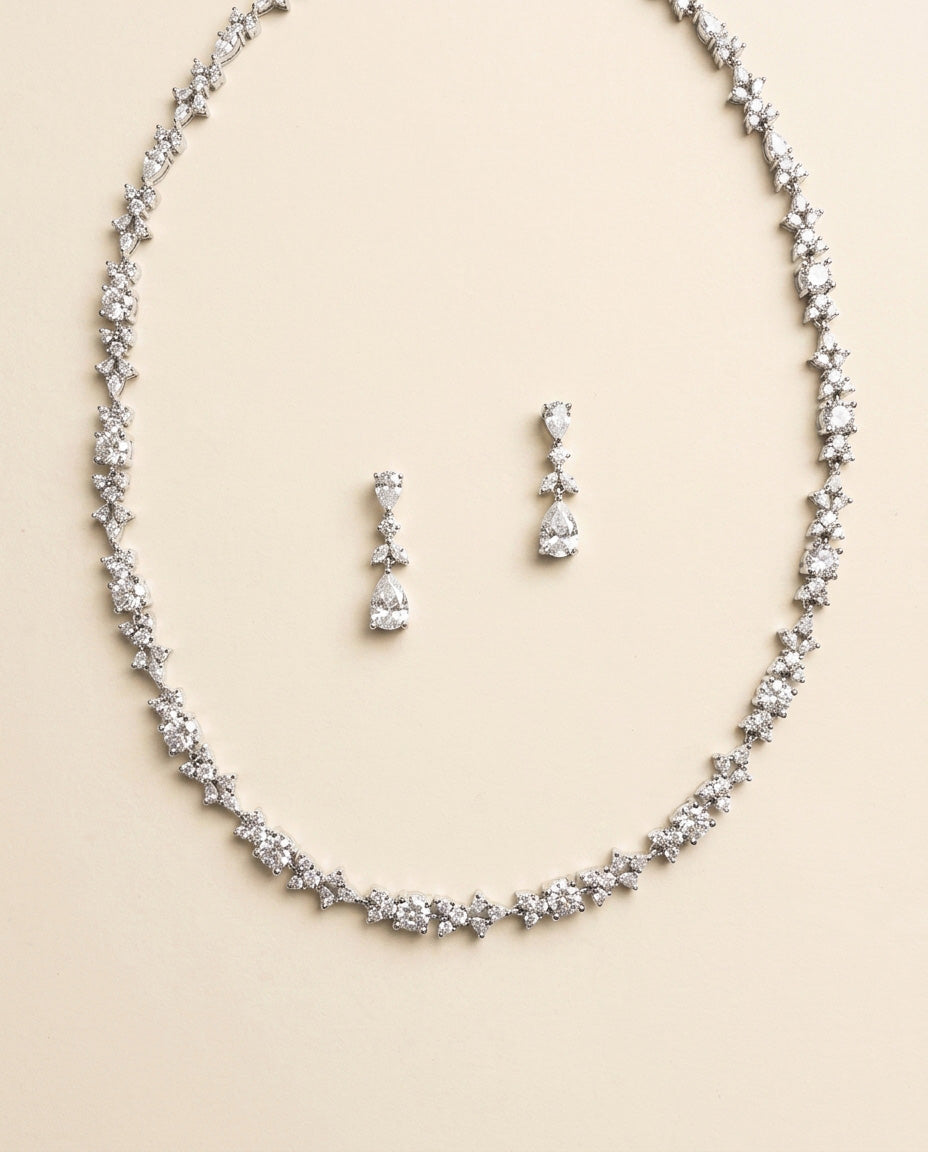 A necklace and earrings set made of sparkling diamonds.