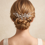 the back view of a woman's head, focusing on her hair and the decorative hair accessory she is wearing.