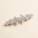 A decorative hair clip with a floral design and sparkling crystal elements.