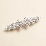 A decorative hair clip with a floral design and sparkling crystal elements.
