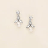 a pair of white pearl and crystal earrings