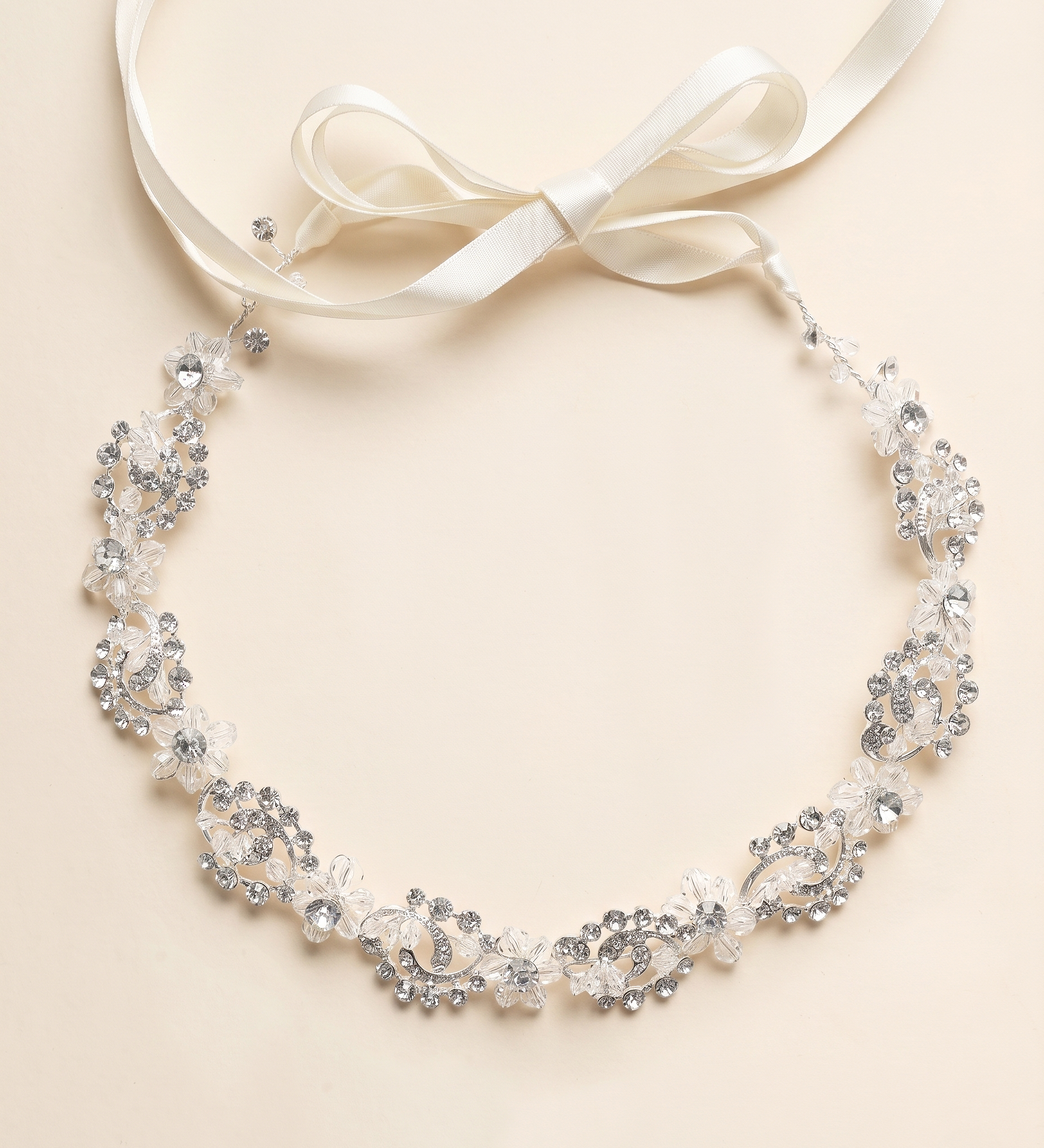 A delicate necklace with a white ribbon and a floral design, featuring small, sparkling crystals.